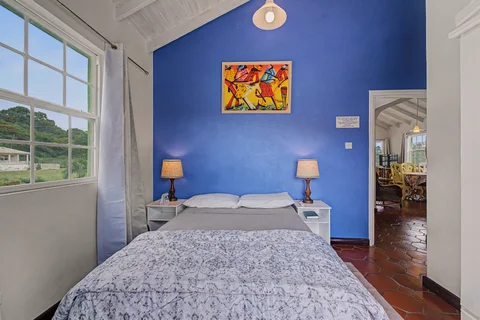 Double bedroom with blue feature wall in the three-bedroom Prospect villa