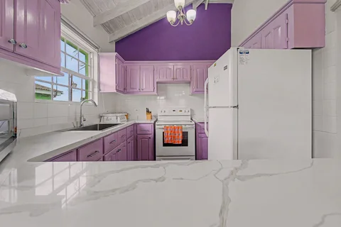 Purple and white equipped kitchen in the three-bedroom Prospect villa