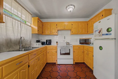 Spacious equipped kitchen with wood cabinetry in the two-bedroom Prospect villa