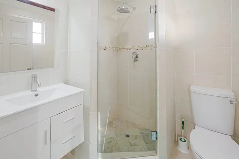 White bathroom with shower at the St. Silas villa